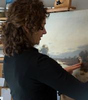 Anne O'Connor examining the damage to a large painting